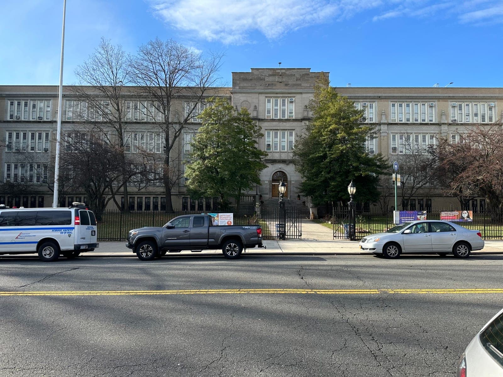 The public school building that houses the gym, seen from across the street on a clear day